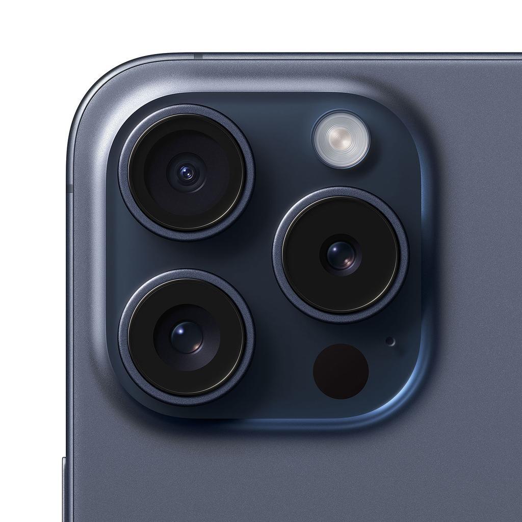 The image shows a close-up view of the rear camera system on the iPhone 15 Pro. The camera module has a matte metallic finish and contains three distinct camera lenses and a LiDAR sensor arranged in a rectangular pattern.
The three circular camera lenses appear to be:

A wide-angle lens
An ultra-wide angle lens
A telephoto lens

The LiDAR sensor, used for depth mapping and augmented reality applications, is positioned below the bottom camera lens.